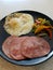 Healthy breakfast with back bacon, over-easy fried egg, and peppers