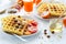 Healthy breakfast. Belgian waffles with nuts and Sicilian oranges