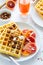 Healthy breakfast. Belgian waffles with nuts and Sicilian oranges