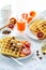 Healthy breakfast. Belgian waffles with nuts and sicilian oranges