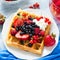 Healthy breakfast: Belgian waffles with sour cream, strawberry, raspberry, blueberry, cherry and red currant