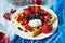Healthy breakfast: Belgian waffles with sour cream, strawberry, raspberry, blueberry, cherry and red currant
