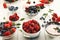 Healthy breakfast with berries and yogurt on white wooden table