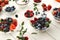 Healthy breakfast with berries and yogurt on white wooden table