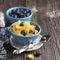 Healthy breakfast. Blue portioned ceramic bowls with corn flakes fresh blueberries