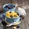 Healthy breakfast. Blue portioned ceramic bowls with corn flakes fresh blueberries