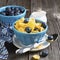 Healthy breakfast. Blue portioned ceramic bowls with corn flakes fresh blueberries