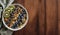 Healthy Breakfast Bowl with Fruits and Granola on Wooden Table, Copy Space