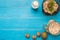 Healthy breakfast with bowl of homemade oatmeal with fruits and milk over rustic wooden background.