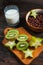 Healthy breakfast - cereal chocolate balls, milk and fruit on wood background