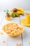 Healthy breakfast with cereal flakes and fruit near vase with