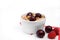 Healthy Breakfast with Cereals, Yogurt, Cherries and Raspberries in White Bowl