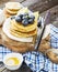 Healthy breakfast classic. Several domestic hot pancakes with fresh ripe blueberry lime zest, honey