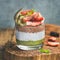 Healthy breakfast concept in glass over wooden board