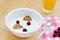 Healthy breakfast containing natural yogurt, wholemeal cereal biscuits and fresh cranberries