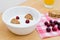 Healthy breakfast containing natural yogurt, wholemeal cereal biscuits and fresh cranberries