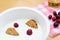 Healthy breakfast containing natural yogurt, wholemeal cereal biscuits and fresh cranberries