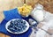 Healthy breakfast with corn flakes, berries, milk on wooden background