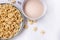 A healthy Breakfast of corn flakes, milk and tea on a white table