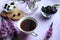 Healthy Breakfast of cottage cheese with blackberries and a Cup of tea on a lilac background, close-up