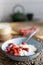 Healthy breakfast - cottage cheese with ripe wild strawberries, almond slices, cappuccino coffee