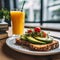Healthy breakfast, delicious toast with avocado, cherry tomatoes and microgreen and glass juice