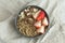 Healthy breakfast. Granola with milk, strawberry and nuts in grey ceramic bowl. Diet food concept