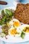 Healthy breakfast: Hard boiled eggs, fresh radish sprouts, arugula and dark whole wheat bread