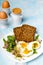 Healthy breakfast: Hard boiled eggs, fresh radish sprouts, arugula and dark whole wheat bread