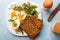 Healthy breakfast: Hard boiled eggs, fresh radish sprouts, arugula and dark whole wheat bread