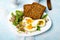 Healthy breakfast: Hard boiled eggs, fresh radish sprouts, arugula and dark whole wheat bread