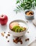 Healthy breakfast. Homemade granola or muesli with apple, kiwi and nuts in a bowl on a white background