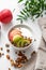 Healthy breakfast. Homemade granola or muesli with apple, kiwi and nuts in a bowl on a white background