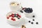 Healthy breakfast with ingredients, milk rice porridge with fresh blueberries, cherries and raspberries, creamy rice