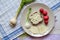 Healthy breakfast made of bread with sheep milk cheese, spring onion, radish and garlic