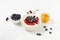 Healthy breakfast with milk rice porridge, fresh blueberries, cherries and raspberries, creamy rice pudding or french