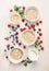 Healthy breakfast: oat flakes in bowls, fresh berries and milk on white wooden background