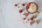 A healthy Breakfast of oatmeal, walnuts and fresh delicious organic strawberries on a light marble background.
