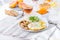 Healthy breakfast plate with scrambled eggs, cheese, grilled mushrooms and sprout micro greens and other snacks and drinks on the