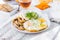 Healthy breakfast plate with scrambled eggs, cheese, grilled mushrooms and sprout micro greens and other snacks and drinks on the