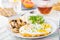 Healthy breakfast plate with scrambled eggs, cheese, grilled mushrooms and sprout micro greens and other snacks and drinks on the