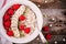 Healthy breakfast: porridge with fresh raspberries, banana, flax seeds and pumpkin seeds