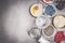 Healthy breakfast preparation with ingredients and empty glass jar on stone background, top view