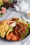 Healthy Breakfast with Salmon, Scrambled Eggs, Avocado and Vegetable Salad on Bright Background