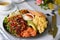 Healthy Breakfast with Salmon, Scrambled Eggs, Avocado and Vegetable Salad on Bright Background