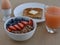 Healthy Breakfast Scene with grapefruite juice, boiled egg, sprouted grain toast, and steel cut oatmeal with fruit.