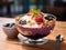 Healthy breakfast smoothie bowl with tropical acai berries, strawberry, banana, blueberry and granola in a glass bowl on table,