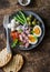 Healthy breakfast or snack - canned tuna, green beans, mozzarella cheese, tomatoes, boiled egg, olives, grilled bread a wooden dar