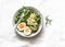 Healthy breakfast or snack - mashed avocado sandwich and boiled egg on a light background