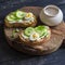 Healthy breakfast or snack - open sandwich with goat\'s cheese and cucumber and boiled quail eggs